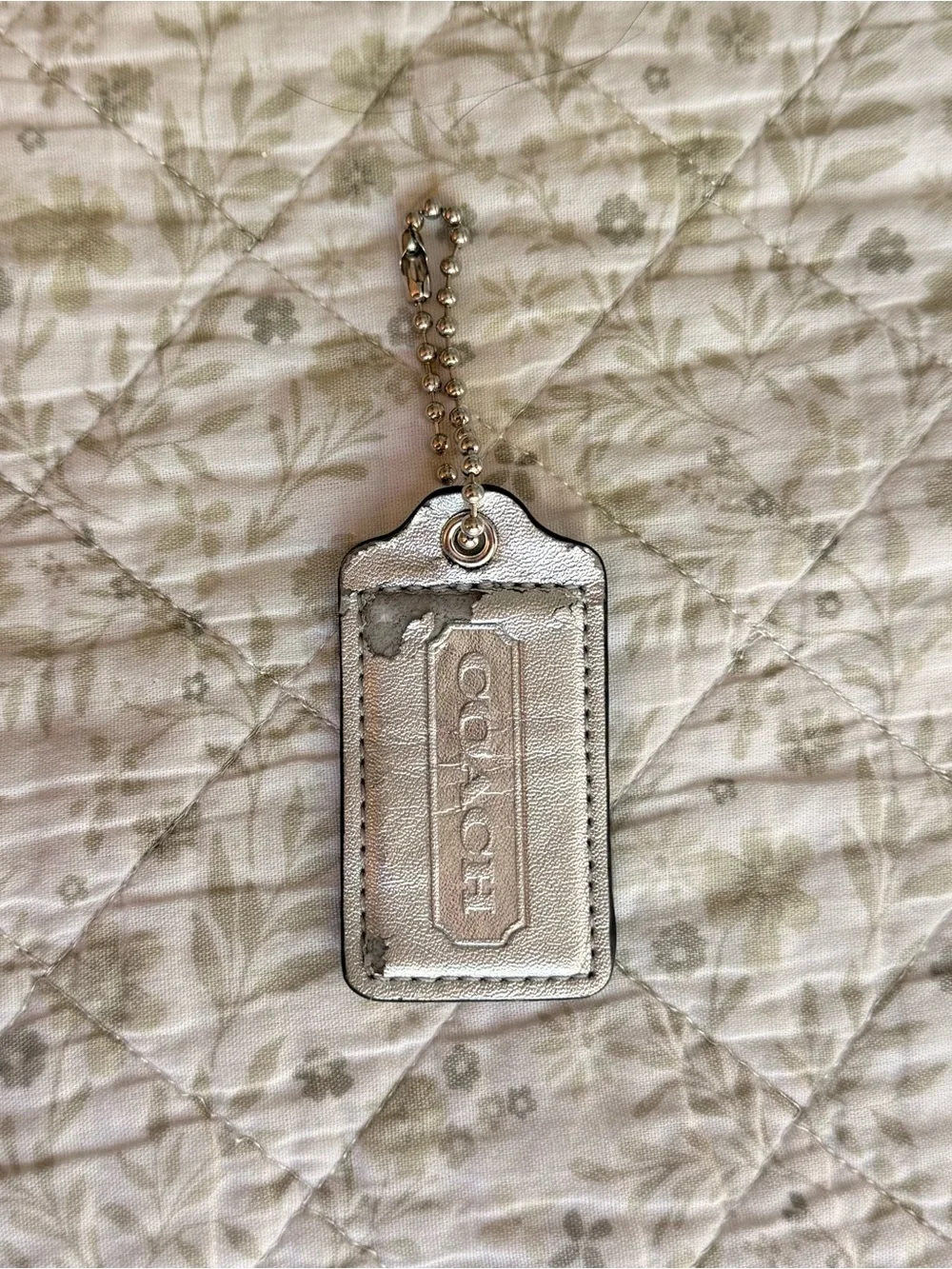 Coach silver metallic hang tag